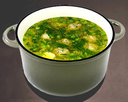 Суп с фрикадельками и зеленым горошком в кастрюле
