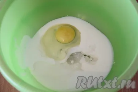 В глубокую миску влить кефир, добавить соду, перемешать и оставить минут на 10. Затем добавить яйцо, растительное масло, соль и сахар. 