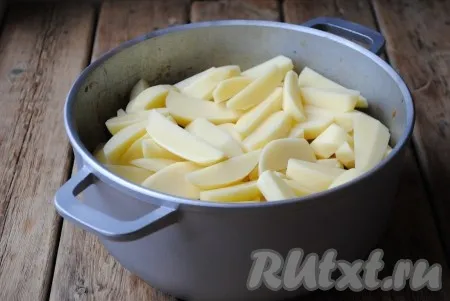 Картофель очистить и нарезать крупными брусочками. Когда куриные желудочки станут мягкими, выложить сверху картошку. 