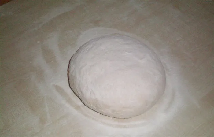 готовое тесто, скатанное в шар, на столе