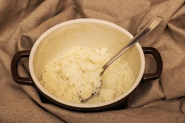 rice porridge and spoon in a pan on a cloth - Рыбные котлеты