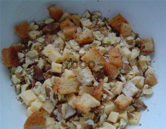 куриная грудка, сыр, пшеничные сухарики и грецкие орехи лежат в миске