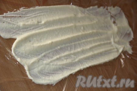 На пищевую плёнку нанести слой крема. 